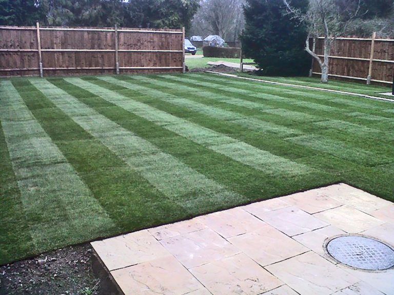 Turfed lawn fencing patio and path landscaping